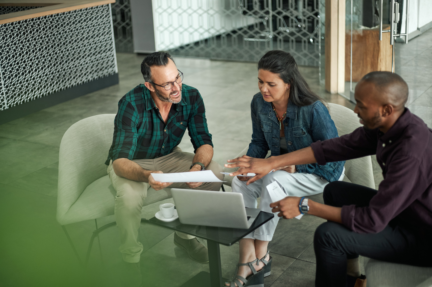 Three people talking about finances 