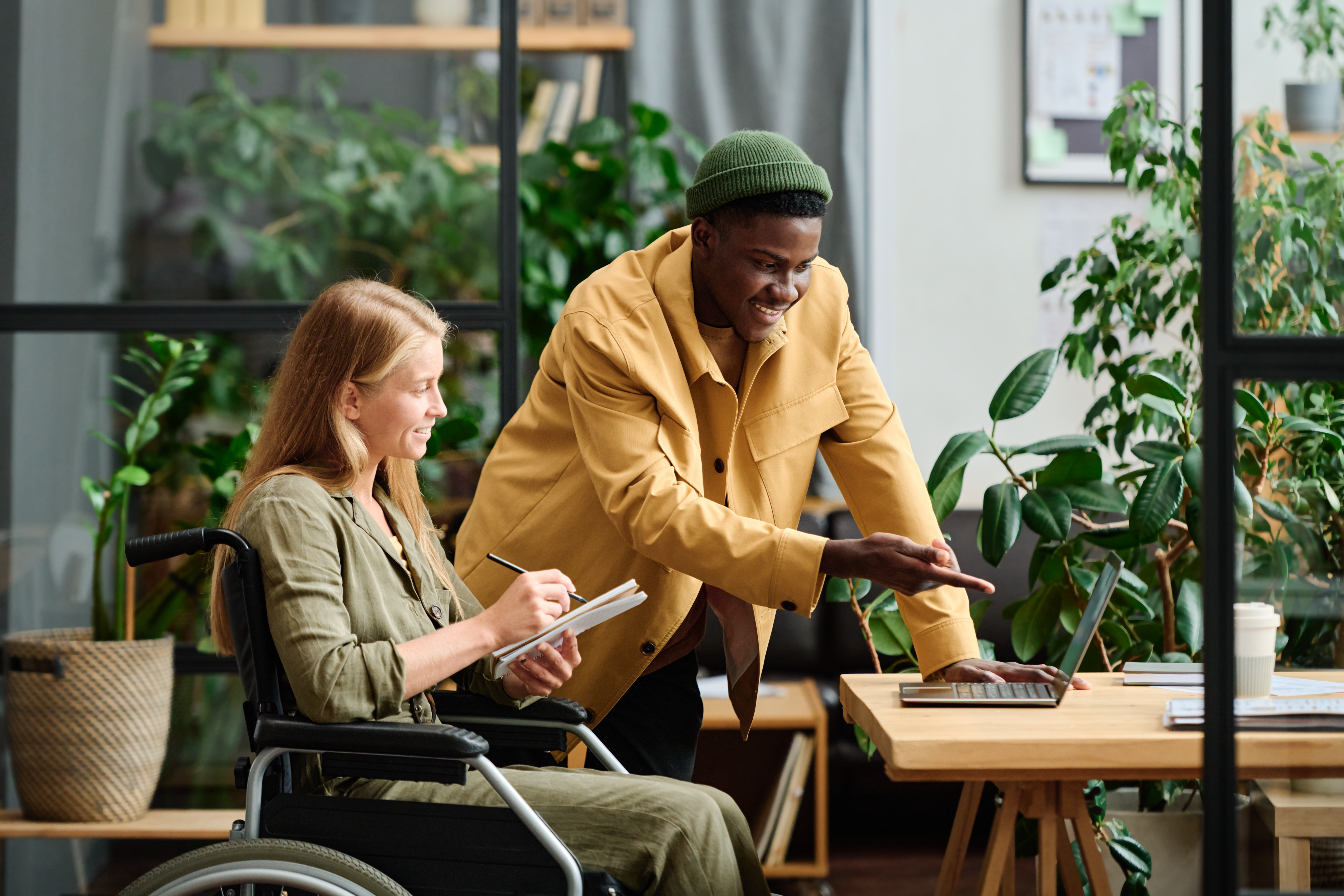 Image of man and girl in a wheelchair in an office